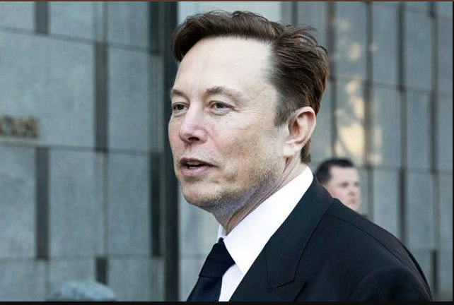 A man in a suit standing outside a modern building, appearing confident and professional.